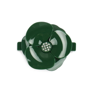 Detailed close-up of dark green floral hair clip with glossy petals and crystal center