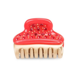 Detail view of red acetate hair claw clip with rhinestones and gold-tone teeth