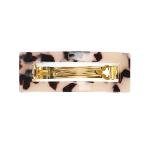 Detail of tortoiseshell acetate hair clip with long rectangular golden metal spring clip