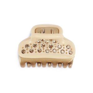 Elegant cream and gold claw clip with champagne crystals for refined hairstyles