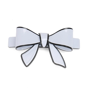 Close-up of a large light blue acrylic bow hair clip with contrasting black edge detail