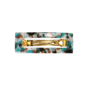 Detailed macro view of the marble pattern acetate hair clip with golden metal spring