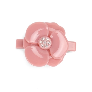Detailed view of a pink camellia hair clip with glossy resin petals and crystal center