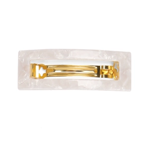 Close-up of pink marble acetate finish and golden metal spring clip for ponytail styling
