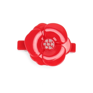 Detail of red camellia hair clip featuring glossy acrylic petals and rhinestone center
