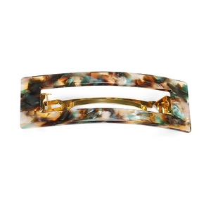 Detail of acetate hair clip showing vintage marble texture and gold spring metal fastener