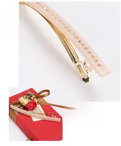 Macro shot of pale pink acetate hair clip with Austrian crystals on golden metal base