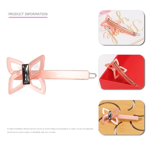Pink acetate butterfly hair clip with grey crystal accent and metallic spring mechanism