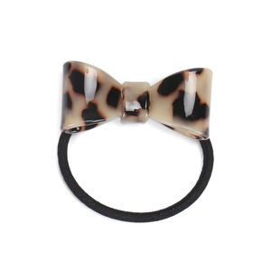 Detail of tortoise shell pattern acetate bow hair tie with black elastic band