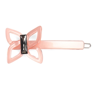 Macro detail of a pink acetate butterfly hair clip with a black rectangular resin gem