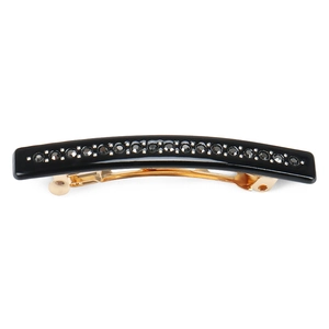 Detail of elegant black acetate hair clip with sparkling rhinestones and golden spring base