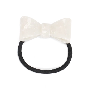 Close-up of cream acetate bow hair tie with marble texture on high elastic black band
