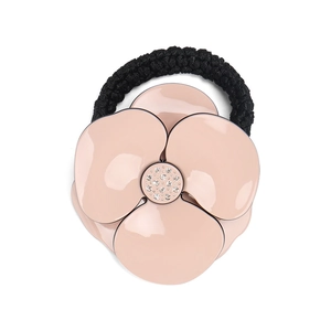 Close-up of pink camellia hair tie with sparkling crystal center and elastic band