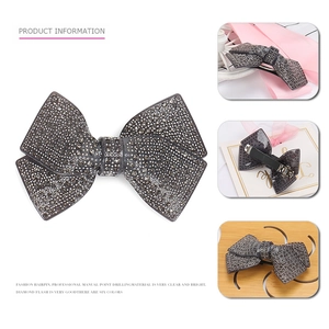 Deep grey acrylic bow hair clip with champagne rhinestones and spring clamp design