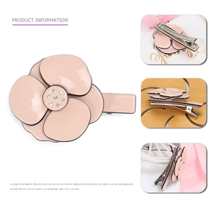 Pink camellia acetate hair clip with crystal center and a secure metal duckbill clamp