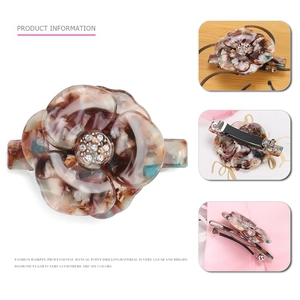 Floral acetate hair clip with sparkling rhinestones in assorted marble patterns