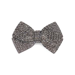 Detail of grey resin bow hair clip with sparkling champagne and dark grey rhinestones