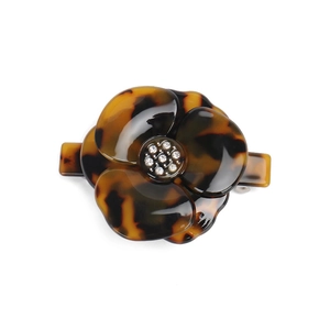 Detail of tortoise shell camellia flower hair clip with sparkling crystal center
