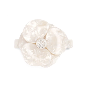 Macro shot of acetic flower hair clip featuring white marble texture and sparkling rhinestones