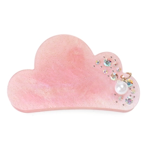 Detail of pink cloud-shaped hair claw clip with glitter resin and pearl charm