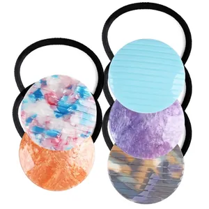 Set of five acrylic elastic hair ties featuring diverse colorful round resin patterns