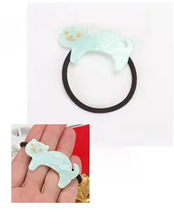 Detail view of mint green acrylic cat hair tie with dimensions 5.6x3cm and 4.9g weight
