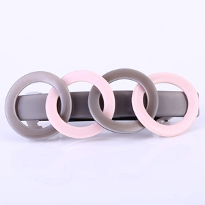 Close-up of interlocking acrylic hair clip rings in Morandi grey and glitter pink