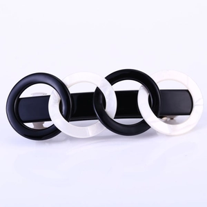 Detail of marble pattern rings and black resin links on a rectangular spring hair clip