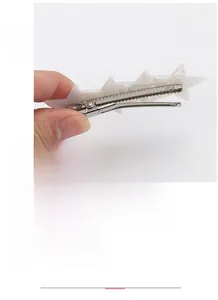 Detailed view of white star acetate hair clip with metal beak showing 8.6x2.7cm size