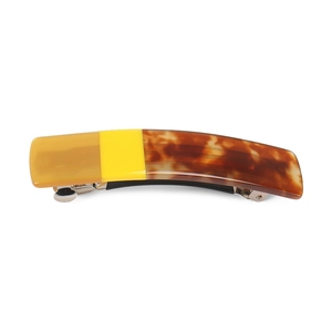 Close-up of multicolor acetate spring hair clip with amber, yellow and tortoiseshell patterns