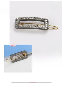 Detail view of gray acetate hair clip with Austria rhinestones and golden metal clip