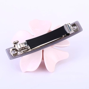 Détail de la pince à cheveux camélia rose avec attache à ressort en métal argenté
