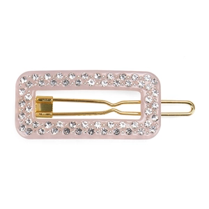 Detailed macro view of a rectangular pink hair clip with sparkling rhinestones and gold alloy base