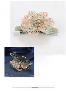 Detailed macro view of hollow flower hair clip with acetate texture and yellow rhinestones