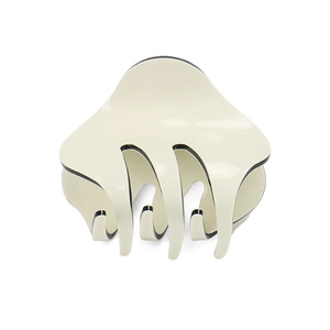 Detail of cream acrylic hair claw clip with black outlines and high gloss finish
