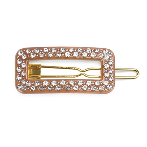Detail view of caramel geometric hair clip with sparkling rhinestones and gold alloy frame