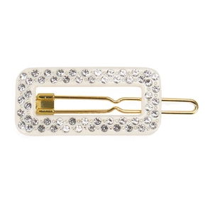 Detail of rectangular hair clip featuring two rows of rhinestones on a gold metal base