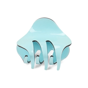 Macro detail of glossy light blue acrylic hair claw clip with smooth curved teeth