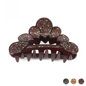 Macro shot of dark red acrylic hair claw clip with colorful rhinestones and color options