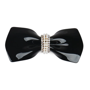 Elegant black bow hair clip with faux pearls and rhinestones on a white background