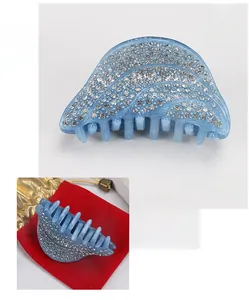 Détail d'une pince à cheveux en acrylique bleu clair avec strass et dimensions précises