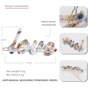 Detailed view of acetate Love hair clip showing dimensions 7.6cm length and 3.9cm height