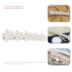 Detail view of pearl hair clip with gold metal base and various white faux pearls