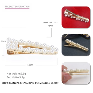 Detailed view of hair clip with pearl dimensions 6.1CM by 2.2CM on golden base