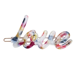 Detailed close-up of marble pattern acetate Love letter hair clip with gold metal base
