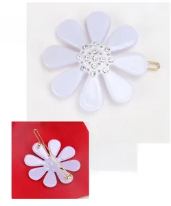 Detailed view of lavender flower hair clip with rhinestones and acetate texture