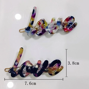 Detailed size view of two colorful acetate Love letter hair clips showing 7.6cm length