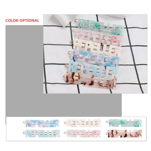 Chic acetate hair clips with REPELLER letter cutout in diverse marble colors