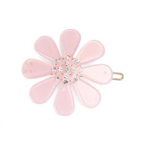 Close-up of pink acetate flower hair clip with sparkling crystals on gold metal clip