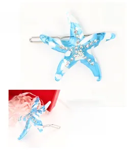 Detailed specs of starfish hair clip made of blue acetate with clear rhinestones and silver pin